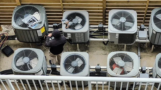 working on a commercial rooftop condensor unit